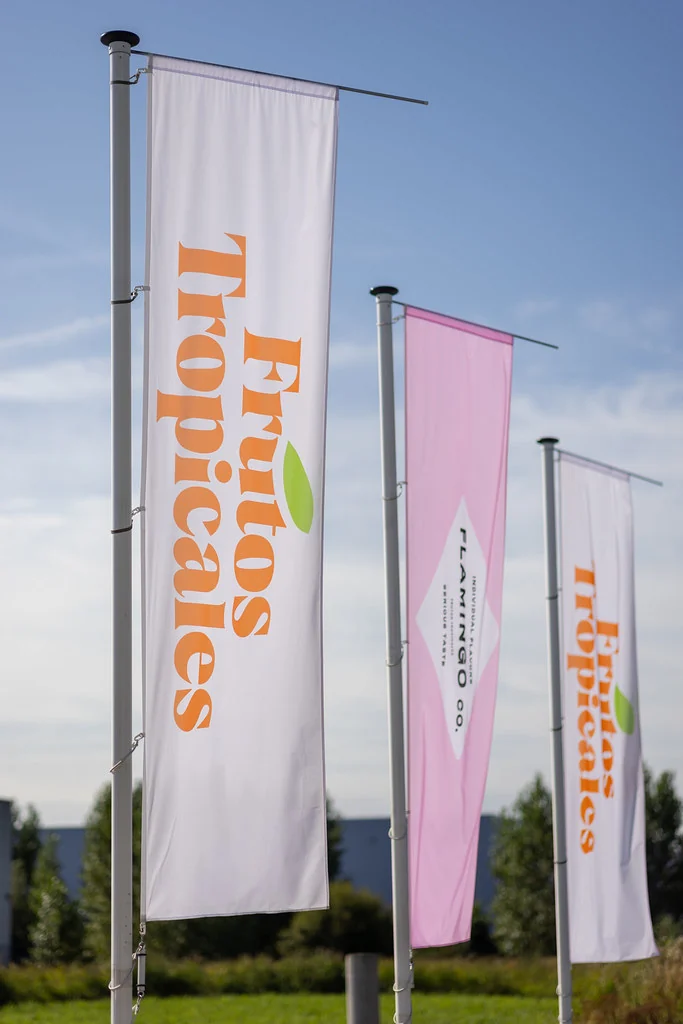 Frutos Tropicales and Flamingo flags outside the facility